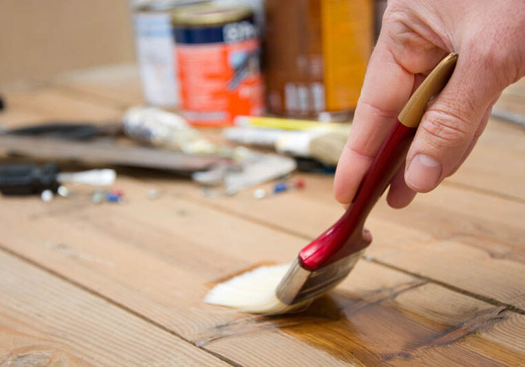 man-varnishing-wood