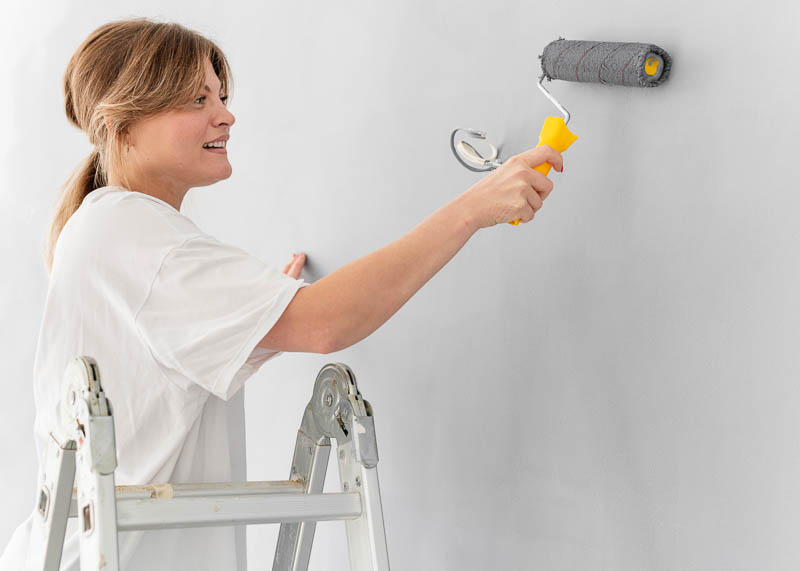 woman-painting-wall-with-roller woman-painting-wall-with-roller